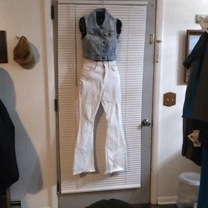 A denim vest and white flared jeans